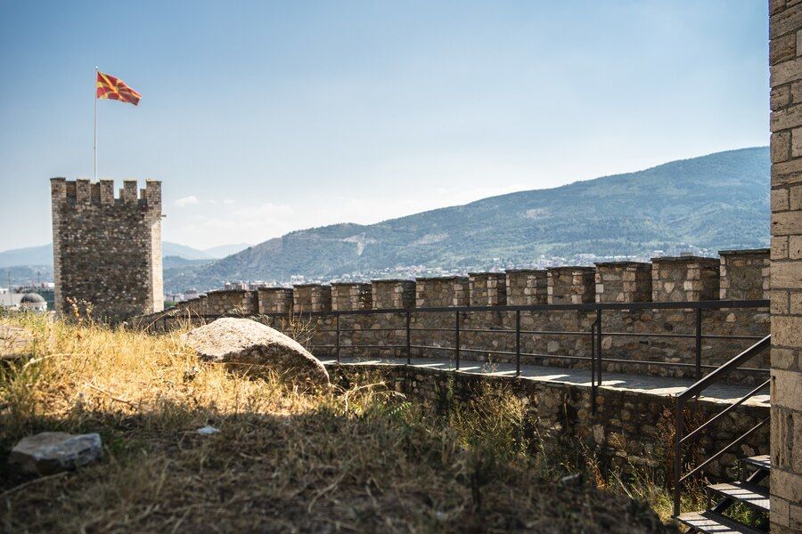 old-castle-with-flag-macedonia-it-surrounded-by-hills-covered-greenery_181624-12704.jpg