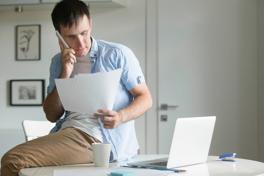half-length-portrait-man-sitting-desk-with-phone_1163-2109.jpg