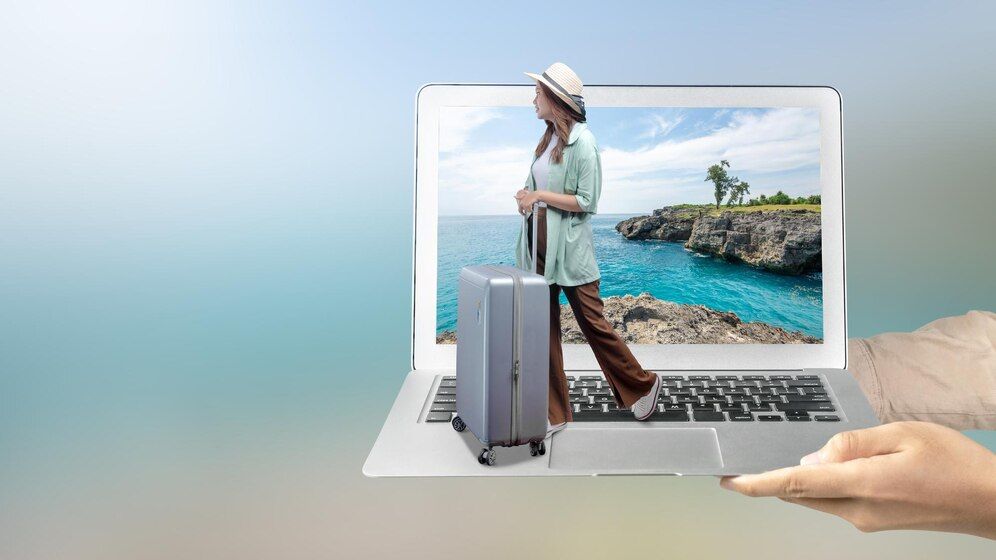 human-hand-holding-laptop-with-asian-girl-hat-suitcase-with-sea-cliff-ocean-view-laptop-screen_9083-22408.jpg