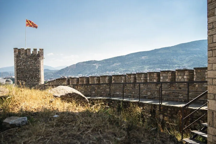 old-castle-with-flag-macedonia-it-surrounded-by-hills-covered-greenery_181624-12704.jpg