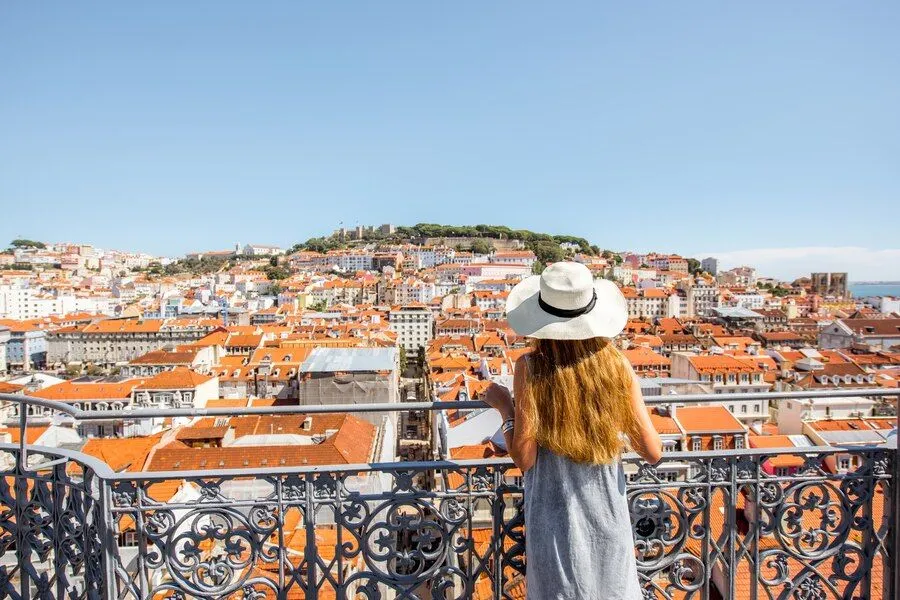 young-woman-tourist-enjoying-beautiful-cityscape-top-view-old-town-sunny-day-lisbon-city-portugal_506452-7588.jpg