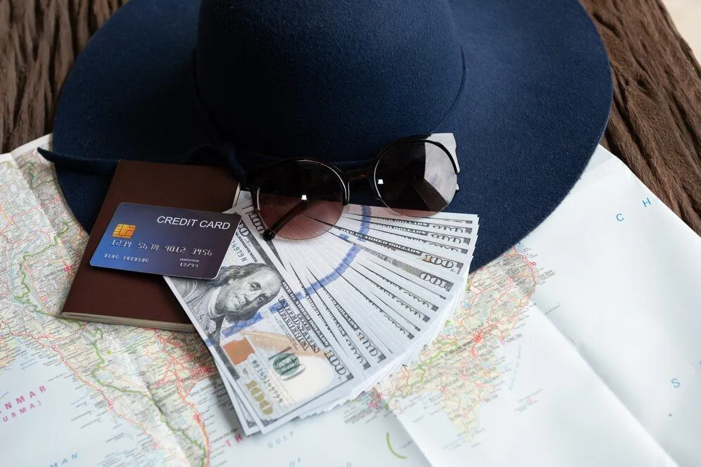 dollar-banknotes-sunglasses-credit-card-passport-blue-hat_1150-18549.jpg